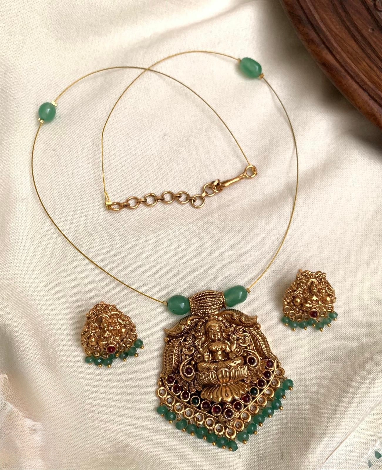 Ananya - Invisible Green Lakshmi Pendant Necklace Set with Matching Earrings